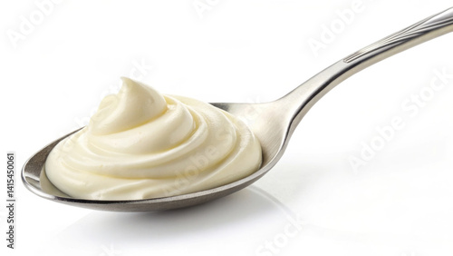 Obraz na płótnie A spoon holds a dollop of creamy sauce, showcasing its smooth texture and inviting swirls. This sauce is commonly used in various dishes to enhance flavor and richness w salonie