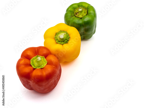 Obraz na płótnie three colored bell peppers isolated on white background w salonie