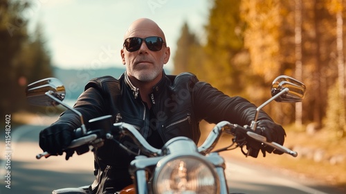 Man in a leather jacket and sunglasses is riding a motorcycle down a road. Concept of freedom and adventure, as the man is enjoying the ride and taking in the scenery