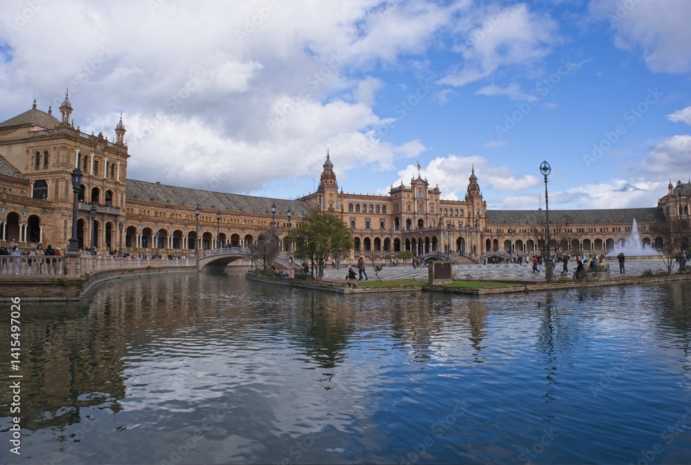 Fototapeta premium Seville, Spain - Mar 23, 2025: Walking in Seville. Plaza de Espana. Streets, buildings. Lifestyle in the urban area. Cloudy spring day. Selective focus