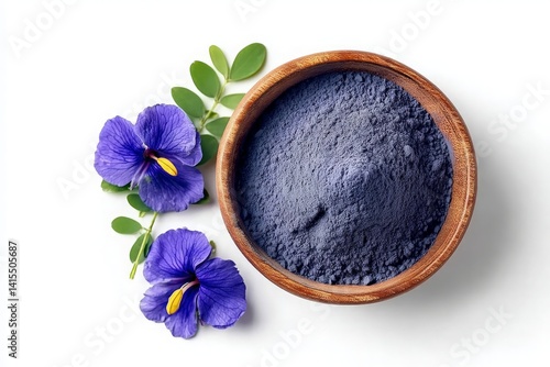 Bright butterfly pea flower powder with blossoms and leaves displayed neatly