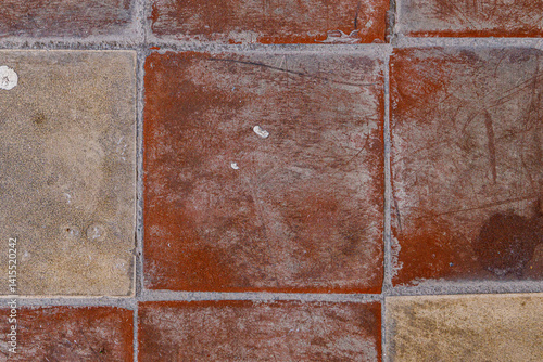 Exploring the rich textures of rustic tiles in a cozy courtyard during a sunny afternoon