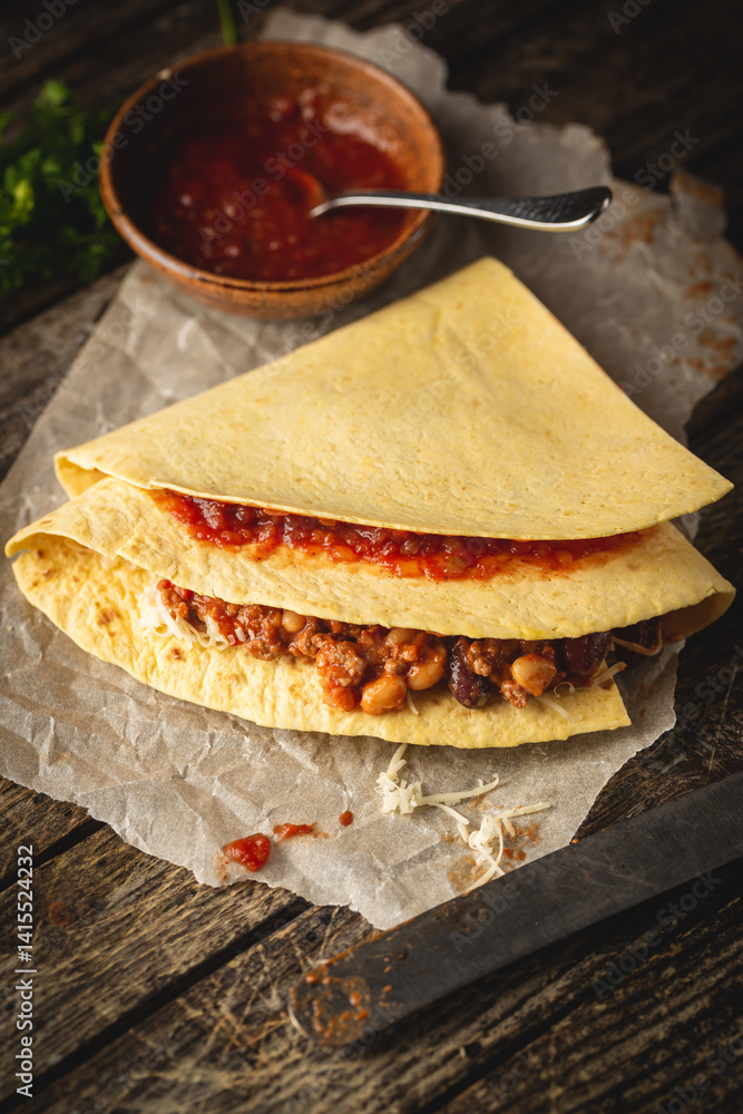 Tortilla wraps sandwiches with fresh vegetables, minced meat and on wooden background. Burrito, sandwich wrap, fajita wrap