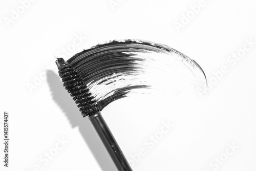 swatch of black ink with a tassel on a white background