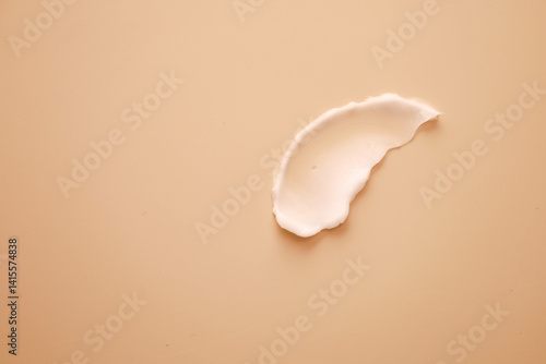 the swatch cream is white on a light beige background with a thick consistency
