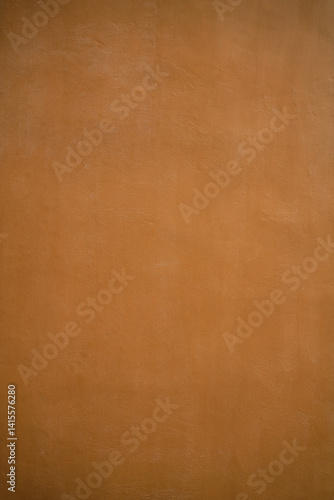 Orange background of a painted wall made of concrete / cement