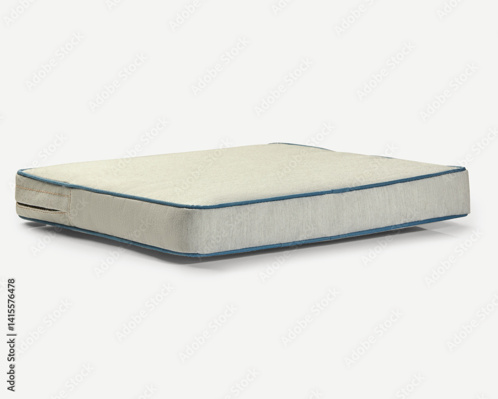 Comfortable mattress pad with blue piping detailing resting on white background