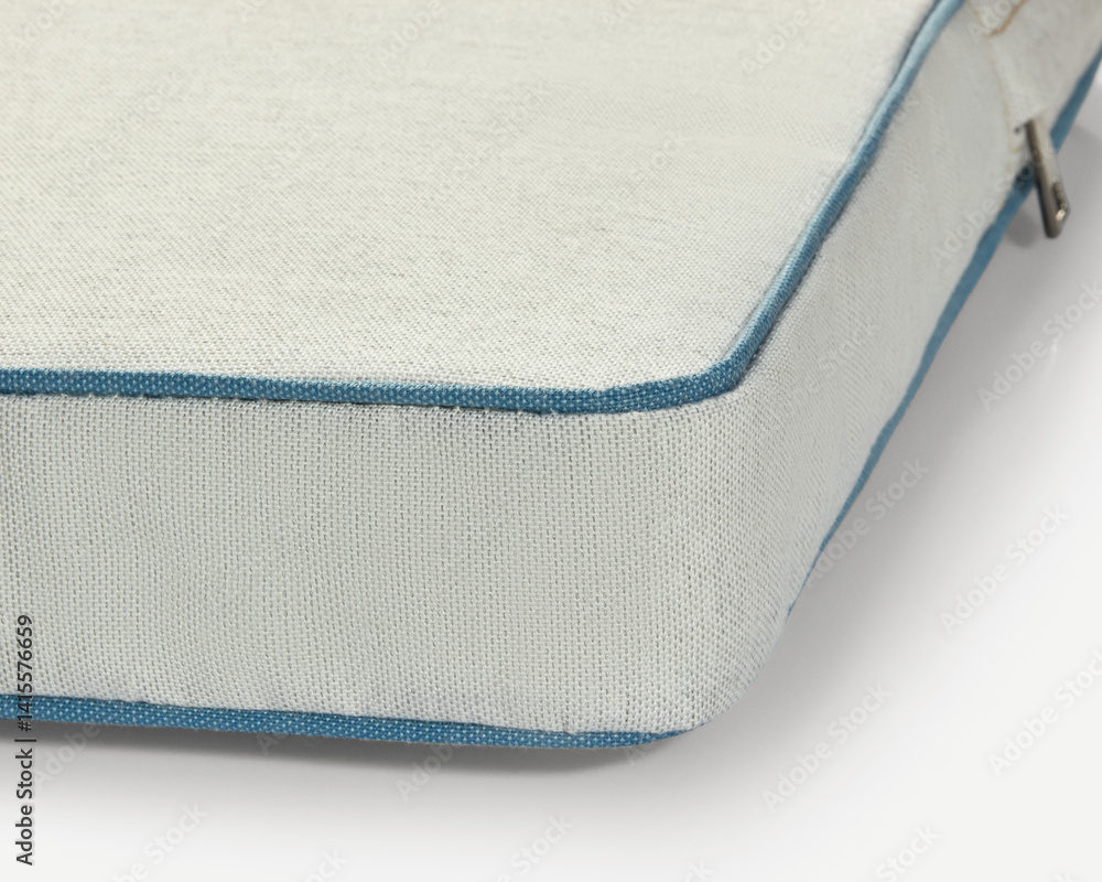 Light beige fabric with blue piping detail showing high-quality manufacturing