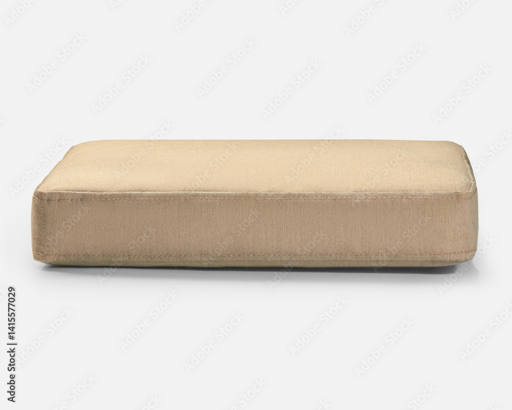 Beige rectangular cushion resting on white surface