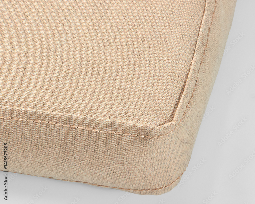 Beige linen cushion corner showing detailed stitching on white background