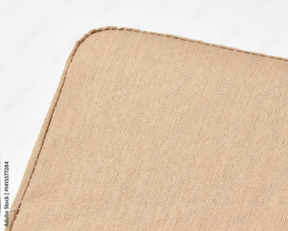 Close-up of beige linen upholstery showing stitching detail