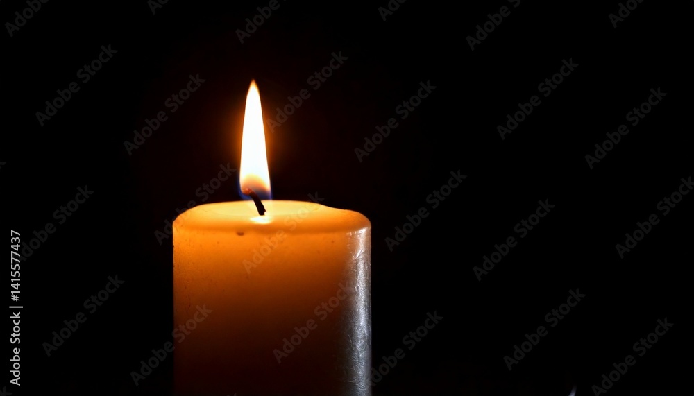 One candle burning slowly isolated on pitch black background One candle burning slowly isolated on pitch black background
