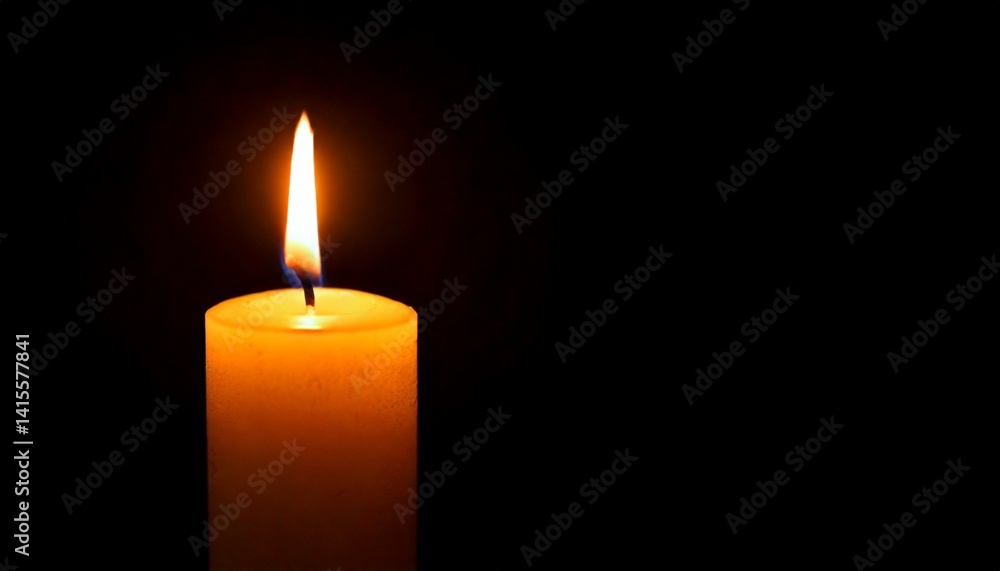 One candle burning slowly isolated on pitch black background One candle burning slowly isolated on pitch black background