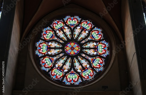Stained glass window in cathedral. Colorful circular glass art in Quito, Ecuador. Religious building interior with gothic architectural design. Rose window, faith, spiritual, church, basilica,