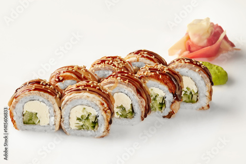 Obraz na płótnie Delicious sushi rolls with eel, cucumber, cream cheese, sesame seeds, and unagi sauce on white background w salonie