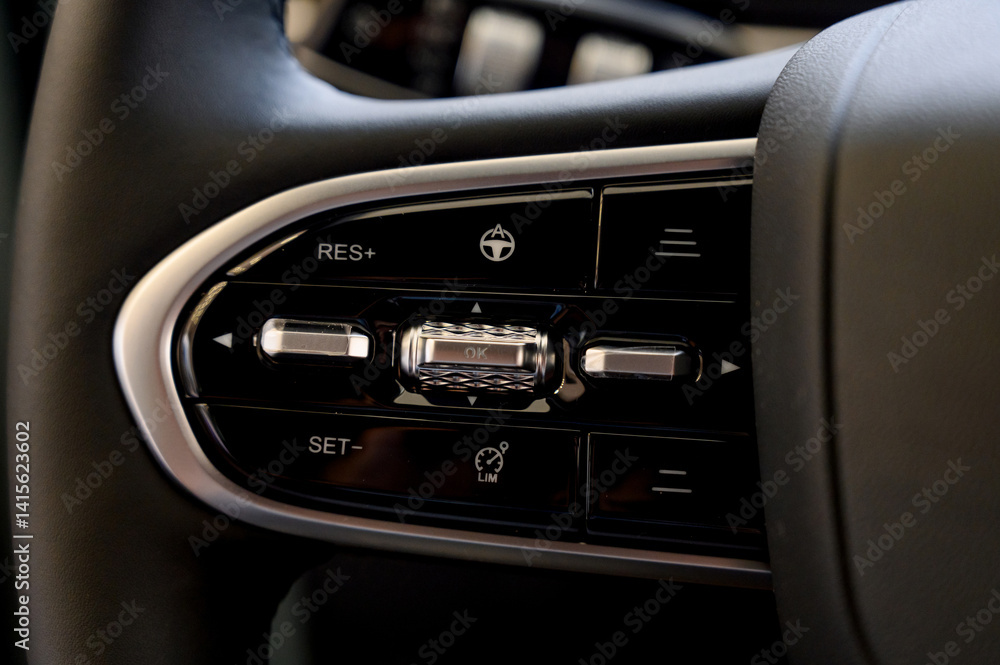 A close-up of a modern car's steering wheel with control buttons A close-up of a modern car's steering wheel with control buttons