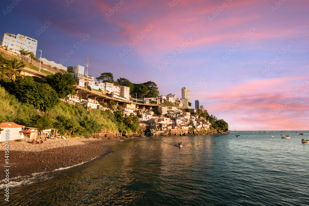 Naklejka premium Colorful hillside homes Gamboa Salvador Bahia overlook the calm sea at sunset
