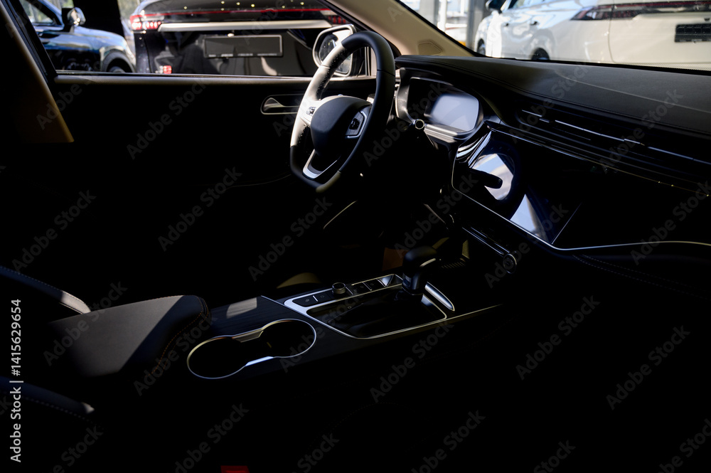 Fototapeta premium Close up of modern new car interior with black leather seats
