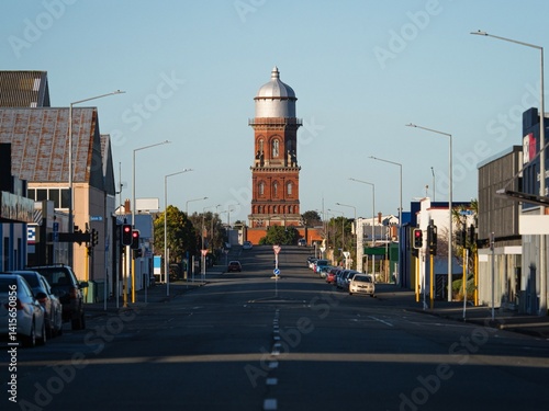 Urban city cityscape road leading to historical red brick stone Invercargill water tower storage with cupola in Southland South Island New Zealand