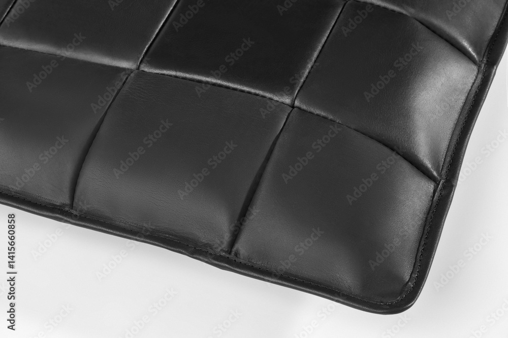 Black leather upholstery creating textured square pattern on furniture
