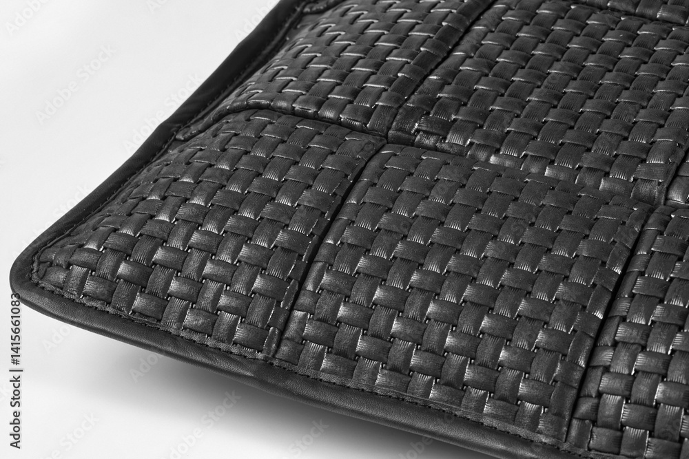 Black leather weave showing interlaced strips creating textured surface