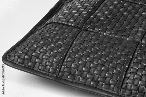 Black leather weave showing interlaced strips creating textured surface
