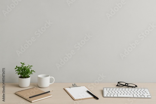 Minimalist Workspace With Notebook, Coffee Cup, and Potted Plant on Wooden Desk