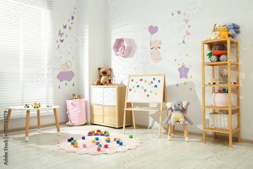 Cuadro en lienzo Cozy playroom with toys, furniture and cute wallpaper
