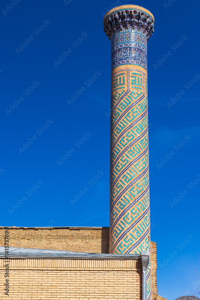 Minaret of Gur-e-Amir is under blue sky, it is a mausoleum complex