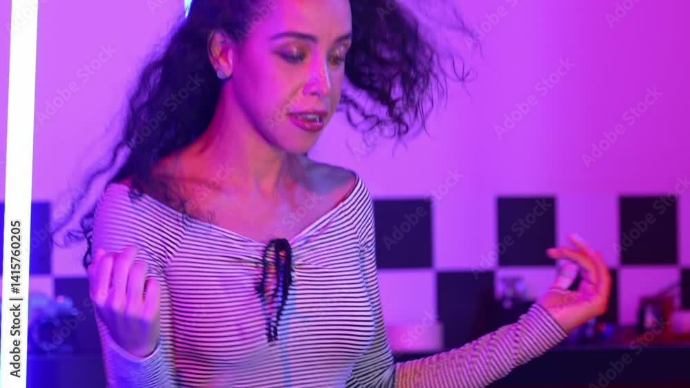 Close up of hispanic street dancer practicing street dancing at studio with purple led light. Professional performer perform energetic movement with stylish cloth. Crazy, funny. Half body. Regalement. Close up of hispanic street dancer practicing street dancing at studio with purple led light. Professional performer perform energetic movement with stylish cloth. Crazy, funny. Half body. Regalement.