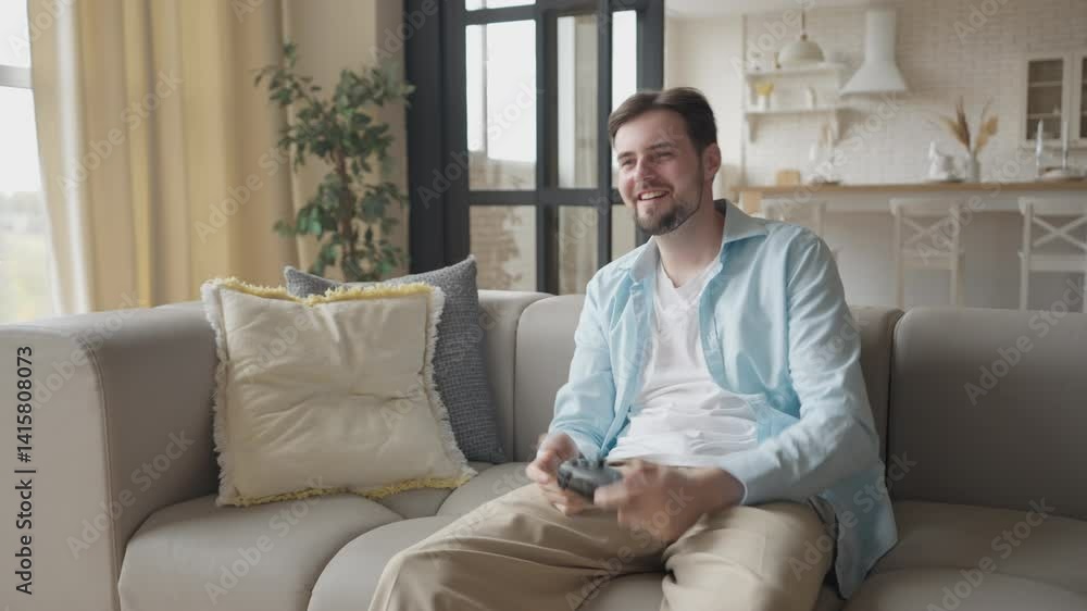 Man Celebrating Video Game Victory With Joyful Expression On Modern Living Room Man Celebrating Video Game Victory With Joyful Expression On Modern Living Room