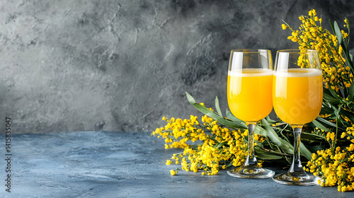 Elegant Mimosa Cocktails With Spring Flowers On Gray Concrete Table
