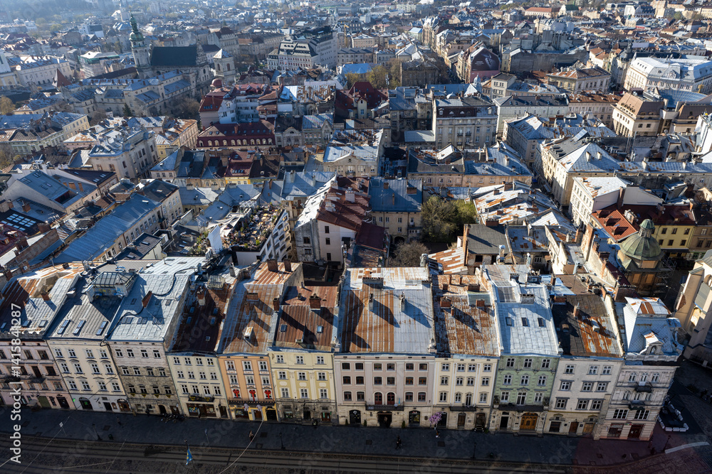 View from above of the main square of Lviv. People are walking around the town