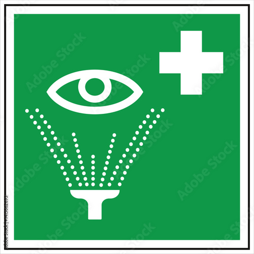Green and white first aid sign indicating the location of an emergency eyewash station for workplace safety