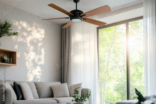 Modern ceiling fan in a cozy room controlled by a remote with natural light streaming through the window 