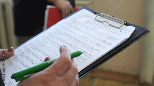 an assessment sheet on a tablet with a pen to fill out