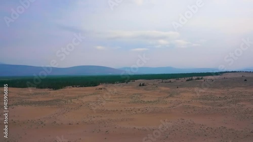 Scenic desert landscape with sand dunes and distant mountains
