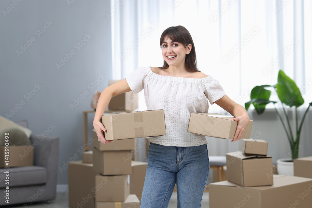 Moving day. Happy woman with cardboard boxes in her new home Moving day. Happy woman with cardboard boxes in her new home