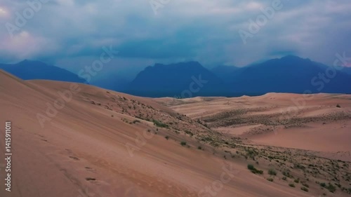 Scenic desert landscape with sand dunes and distant mountains