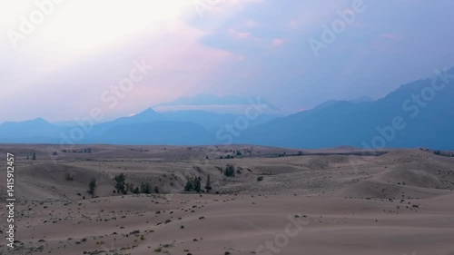 Scenic desert landscape with sand dunes and distant mountains