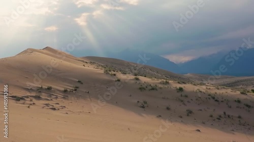 Scenic desert landscape with sand dunes and distant mountains