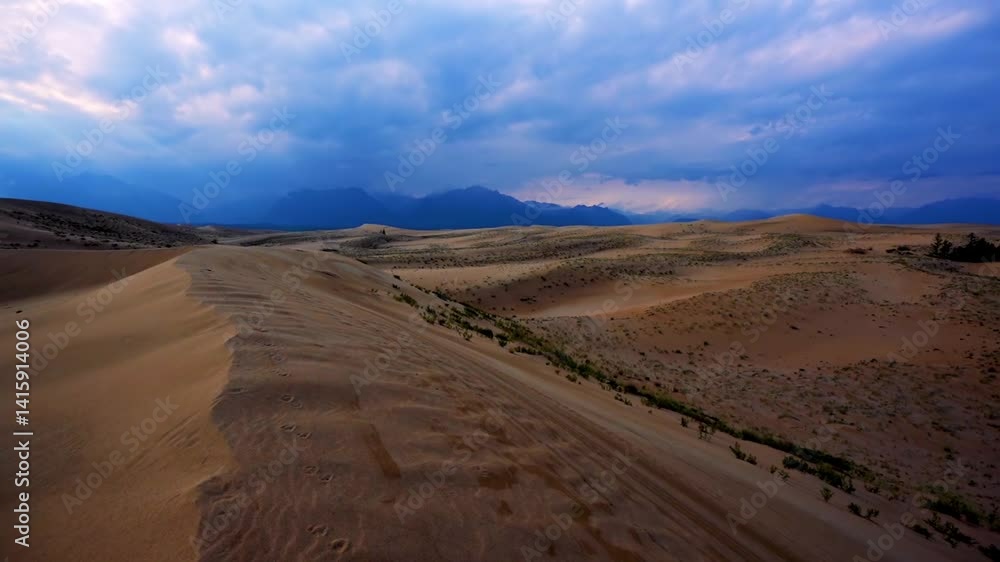 Scenic desert landscape with sand dunes and distant mountains Scenic desert landscape with sand dunes and distant mountains