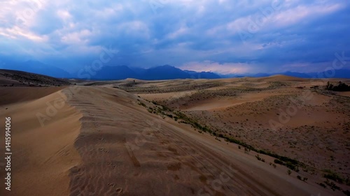 Scenic desert landscape with sand dunes and distant mountains