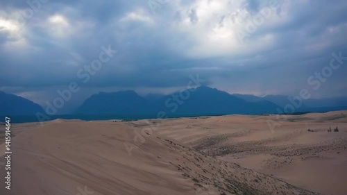 Scenic desert landscape with sand dunes and distant mountains