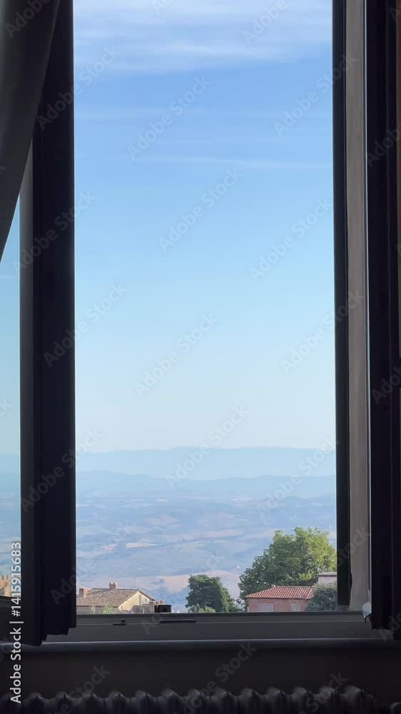 A stunning view through the window shows rolling hills under a vast blue sky, inviting peace A stunning view through the window shows rolling hills under a vast blue sky, inviting peace
