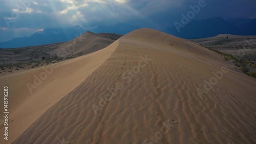 Scenic desert landscape with sand dunes and distant mountains