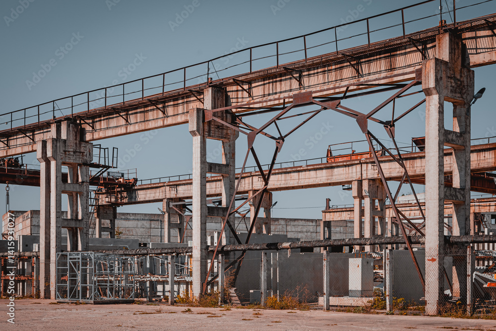 Naklejka premium Old rusty factory building and equipment. Heavy industry steel mill technology mechanisms and tools. Rusty construction equipment on working factory.