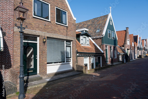 Tourists destination in North Holland, old authentic fishermen village Volendam near Amsterdam with old houses and narrow streets
