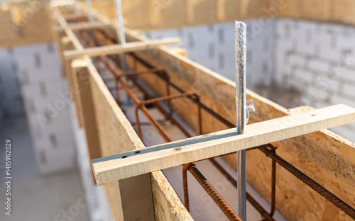 Reinforced Concrete Beam Formwork with Metal Rebar and Wooden Frame at Construction Site Close-Up View
