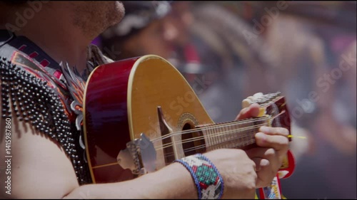 Musician Playing Traditional String Instrument in Cultural Celebration 